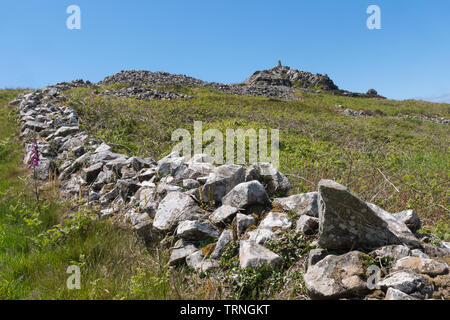 Strumble Kopf Küstenlandschaft, robuste felsige Landschaft mit Trockenmauer und trig Point, im Sommer in Pembrokeshire, Wales, Großbritannien Stockfoto