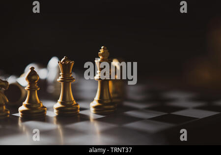 Golden Schach spiel König, Königin, Bischof bleiben an Bord, Business planing starke Konzept mit dunklem Hintergrund. Stockfoto