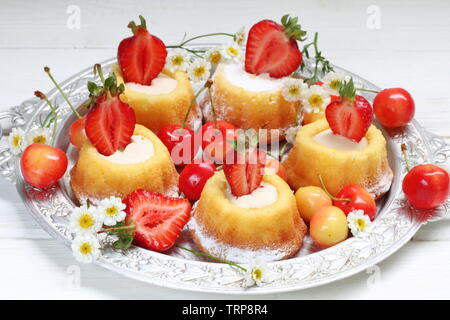 Cupcakes mit Erdbeeren auf einem weißen Holz- Hintergrund Stockfoto