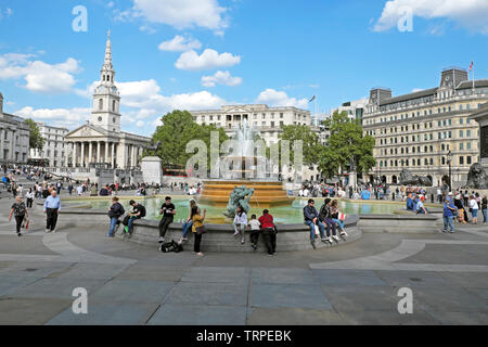 Touristen, die im Frühjahr 2019 am Brunnen am Trafalgar Square saßen, bevor sie in der City of Westminster, Central London England, Großbritannien, KATHY DEWITT, kovidierten Stockfoto