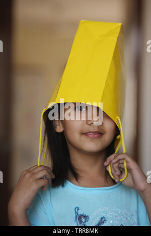 Porträt eines indischen Mädchen tragen eine Papiertüte Stockfoto