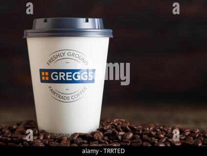 LONDON, UK - Juni 05, 2019: Greggs Kaffee Pappbecher für nehmen Sie mit Kaffeebohnen auf Holz. Stockfoto