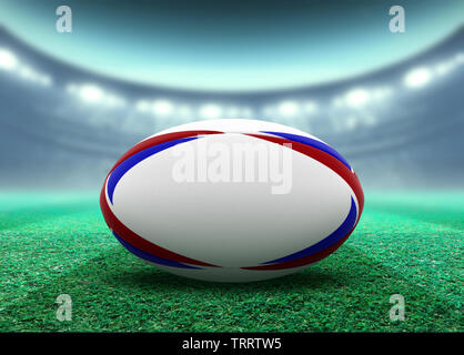 Eine reguar Weiß rugby ball mit roten und blauen Design Elemente auf ein Stadion rasen in der Nacht ruht unter beleuchtet Fluter - 3D-Rendering Stockfoto