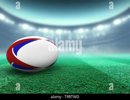 Eine reguar Weiß rugby ball mit roten und blauen Design Elemente auf ein Stadion rasen in der Nacht ruht unter beleuchtet Fluter - 3D-Rendering Stockfoto