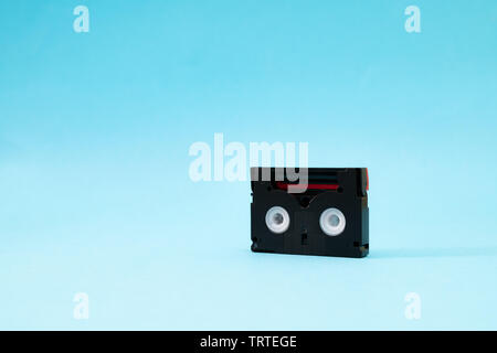 Vintage Mini-DV-Kassette für die Aufnahme von Video zurück in einem Tag verwendet. Kunststoff, magnetisch, analogen Film tape auf blauem Hintergrund Stockfoto