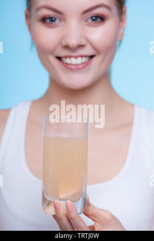 Vitamine, Gesundheit, Medizin. Frau mit Glas mit orange aromatisiert Vitamin Mineralfutter Brausetablette in Wasser gelöst. Studio shot o Stockfoto