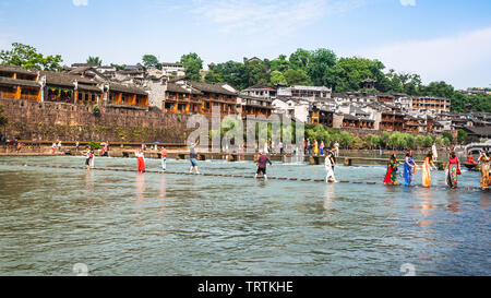 2. Juni 2019, Fenghuang China: Chinesische Touristen auf Brücke über Tuo Jiang River und alten Festung im Hintergrund in Phoenix, antike Stadt in Hunan Ch Stockfoto