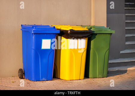 Mülleimer, Mülleimer, Papierkorb in Ferienanlage Resort, Warten von Müllwagen abgeholt zu werden. Blau, Gelb und Grün Behälter für Abfälle. Stockfoto