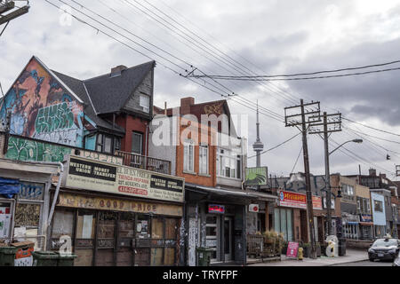 TORONTO, KANADA - 14. NOVEMBER 2018: Typische Kensington Market Street mit dem CN Tower im Hintergrund. Kensington Market ist ein Hipster in nach unten Stockfoto