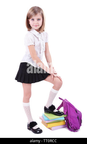 Schöne kleine mit Rucksack und Bücher isoliert auf weißem Stockfoto