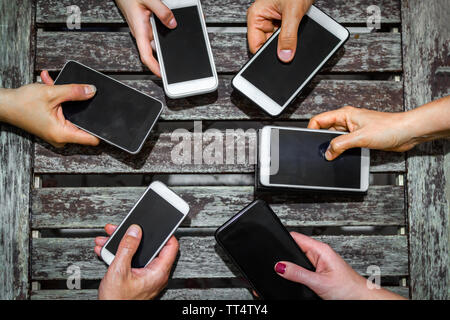 Blick von oben auf einen mit Handy zusammen Gruppe von Teenagern - mobile Internet Messaging Telefon sucht - neue Generation jugendliche Zeit Stockfoto