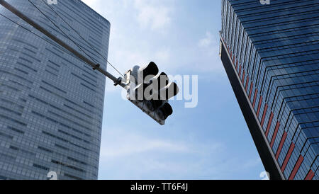 Tokyo, Japan - 13. Mai 2019: eine Ampel mit zwei Hochhäusern im Hintergrund. Blick auf ein Winkel nach oben. Stockfoto