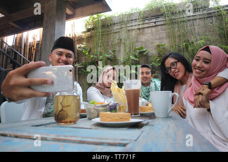 Eine Gruppe von Freunden, die selfie am Tisch speisen während des Ramadan Feier Stockfoto