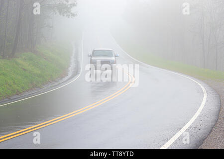 Horizontale Schuß eines einsamen Pickup Truck fahren durch dichten Nebel mit kopieren. Stockfoto