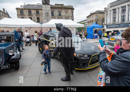 Paisley, Schottland, Großbritannien. 15 Juni, 2019. Ein junger Junge trifft Batman an Paisley Carfest 2019 In diesem Jahr feiert er den 6-jähriges Jubiläum. Gezeigt werden eine Reihe von klassischen Fahrzeugen, Oldtimer, Spezialist kundenspezifische Autos, Muscle Cars, supercars und Einsatzfahrzeuge. Alle Spendengelder gehen an dem Tag, an dem St. Vincent's Hospiz in Howwood zu unterstützen. Credit: Skully/Alamy leben Nachrichten Stockfoto