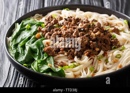 Rezept für dan dan Nudeln mit Hackfleisch und Grünen closeup in einem Teller auf dem Tisch. Horizontale Stockfoto