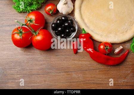 Teig Grundlage und Zutaten für Pizza, auf dem Tisch Stockfoto