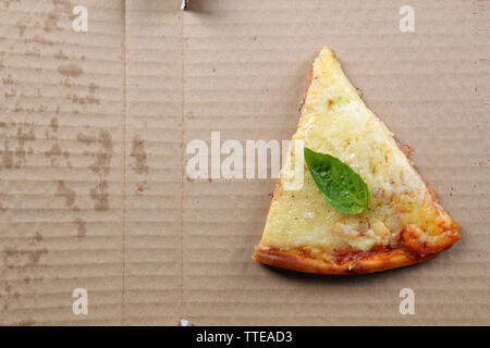 Leckere Scheiben Pizza mit Basilikum auf Kartons, in der Nähe Stockfoto