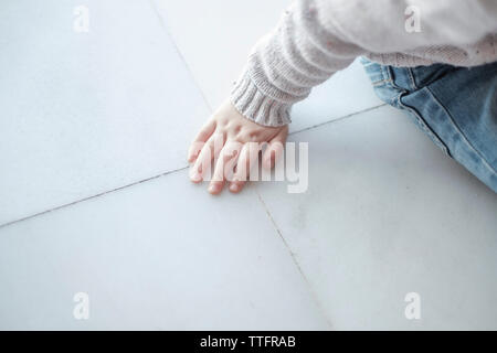 Boy's Hand auf Weiß, sitzend Stockfoto