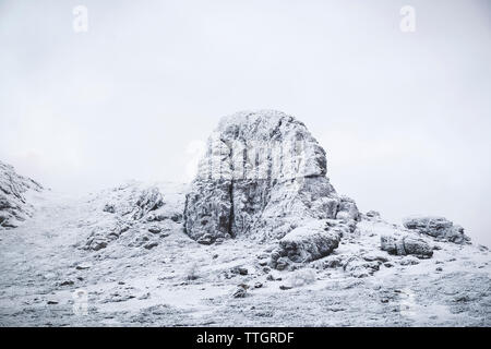 Schneebedeckte Felsen gegen klaren Himmel Stockfoto