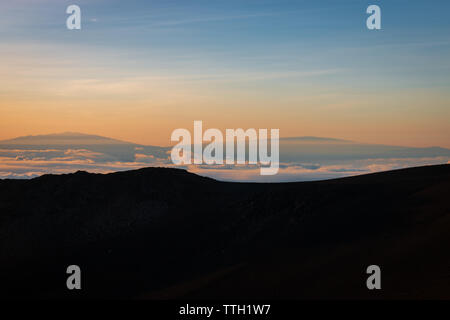 Gipfel des Mauna Kea, Big Island von Haleakala auf der hawaiianischen Insel Maui, USA gesehen bei Sonnenaufgang Stockfoto