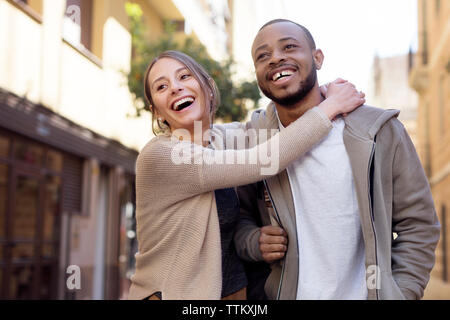 Frau sucht Mann umarmen beim Stehen auf Stadt. Stockfoto