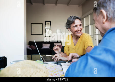 Heiter, reife Frau Planung Urlaub mit älteren Menschen zu Hause. Stockfoto