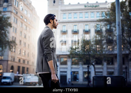 Low Angle View der Mann mit Tasche, beim Gehen auf der Straße in der Stadt Stockfoto