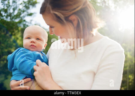 Lächelnde Frau mit baby boy im Park Stockfoto