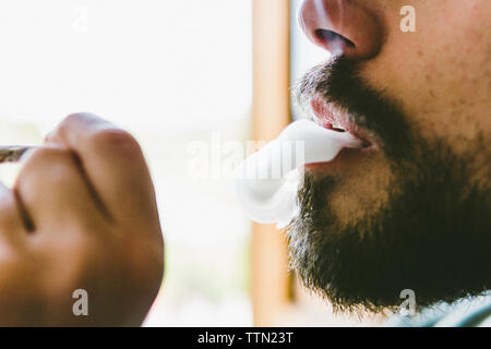 Mittelteil der bärtige Mann Rauchen von Marihuana gemeinsame Stockfoto