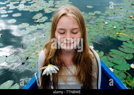 Nahaufnahme der glückliche Frau mit geschlossenen Augen sitzen im Boot auf dem See Stockfoto