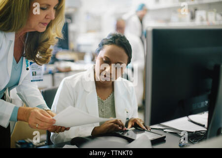Ärztin zeigen Berichte in der medizinischen Zimmer zu Kollegen Stockfoto