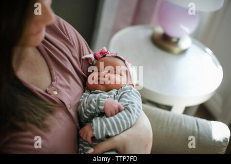 Mittelteil der Mutter tragen Schlafen neugeborene Tochter zu Hause Stockfoto