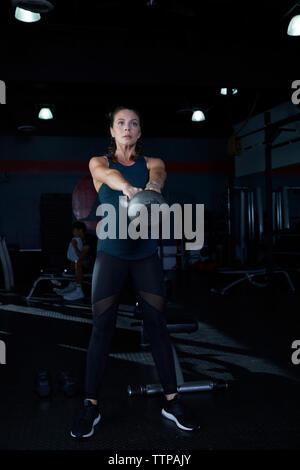 Frau heben kettlebell während des Trainings in der Turnhalle Stockfoto