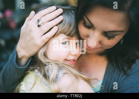 Portrait von glücklichen Mädchen umarmt Mutter Stockfoto