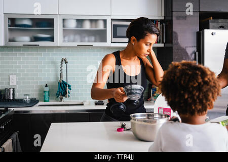 Mutter mit Sohn, die Zubereitung von Speisen in der Küche zu Hause.