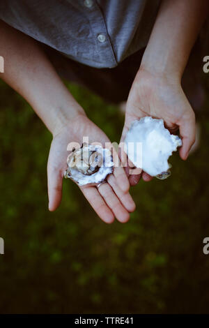 Untere Partie der Mann mit austernschalen auf Rasen Stockfoto