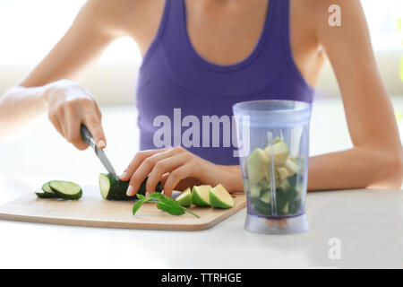 Mädchen Schneiden von Gemüse und Obst auf Küche Stockfoto