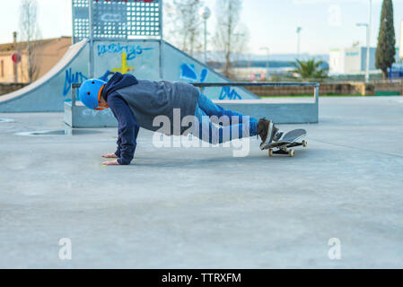 Ansicht der Rückseite des jungen Skater einen Trick auf Masse an Skate Park Stockfoto