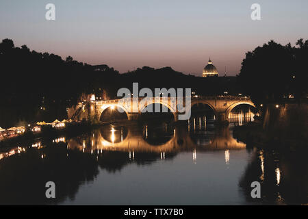 Die Brücke Ponte Sisto in Rom über den Tiber in der Nacht. Es ist schön beleuchtet in der Nacht und in der Ferne gibt es einen Basilic sichtbar. Stockfoto