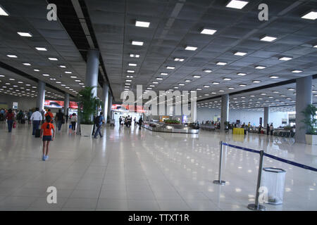 Passagiere, die an einem Flughafenterminal, dem Suvarnabhumi Airport, Bangkok, Thailand, zu Fuß unterwegs sind Stockfoto