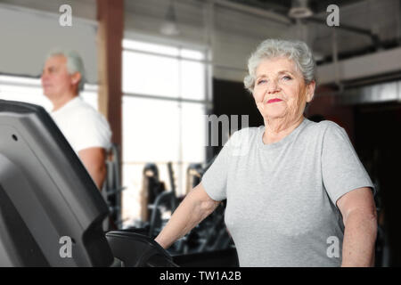 Ältere Frau auf Laufband im Fitnessstudio Stockfoto