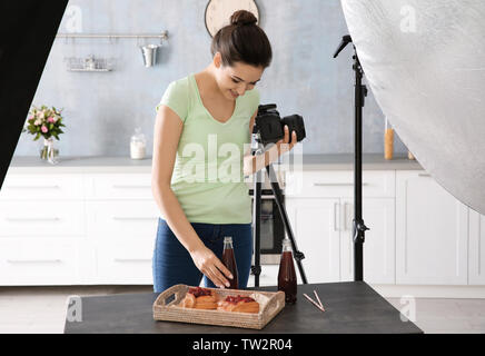 Junge Frau fotografieren Essen in Photo Studio Stockfoto