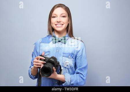 Schöne junge Fotografen auf hellen Hintergrund Stockfoto