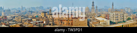 Panoramablick auf das Stadtbild von Islamischen Kairo mit Blick auf alte Wohnhäuser, zahlreichen Minaretten und Kuppeln der Moscheen, mit schweren Morgennebel abgedeckt, z. B. Stockfoto