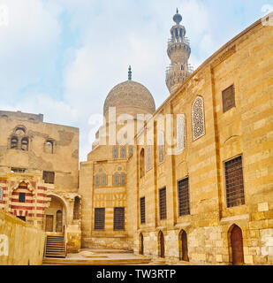 Die Mauer der mittelalterlichen Residenz und die geschnitzten Kuppel der Moschee von historischen Amir Khayrbak Grabkunst Komplex, Kairo, Ägypten Stockfoto