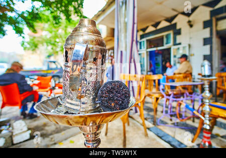 Die Nahaufnahme von Holzkohle Fach und Schüssel von Shisha (Wasserpfeife) mit Blick auf den kleinen outdoor Teehaus auf dem Hintergrund, Kairo, Ägypten Stockfoto