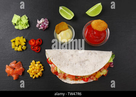 Zutaten für Fisch Tacos auf dunklem Hintergrund Stockfoto