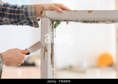 Mitarbeiter Entfernen von Lack von alten Fensterrahmen, Nahaufnahme Stockfoto