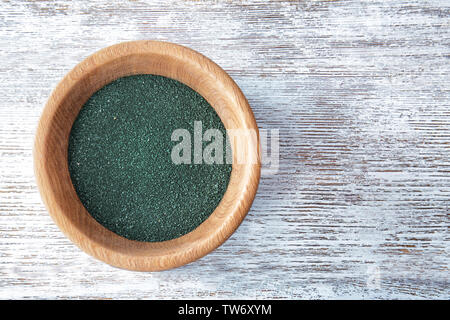 Spirulina Pulver in Schüssel auf Holz- Hintergrund Stockfoto